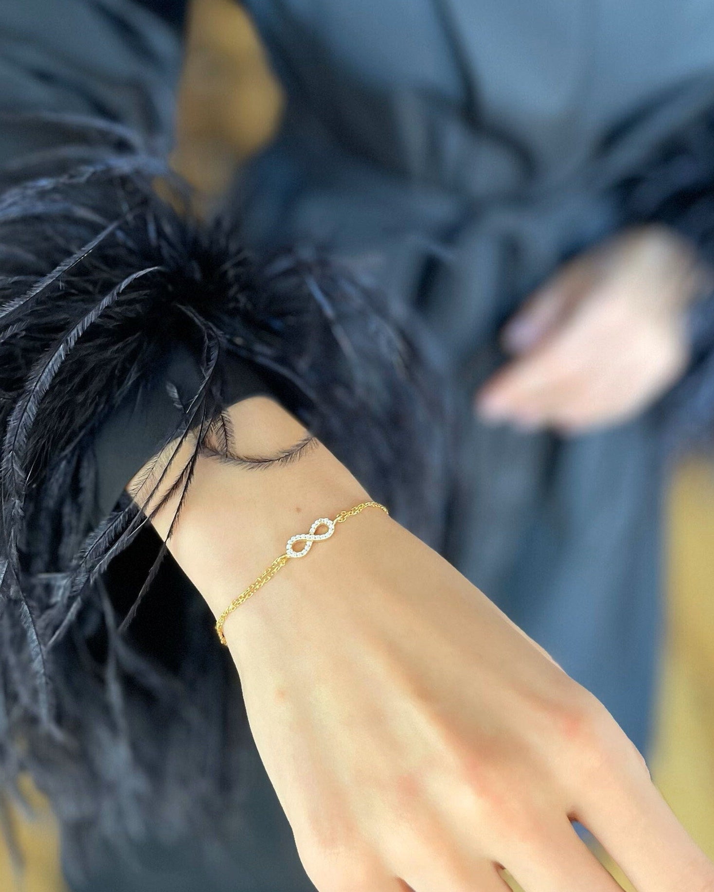 Gold bracelet on a wrist with a blurred background