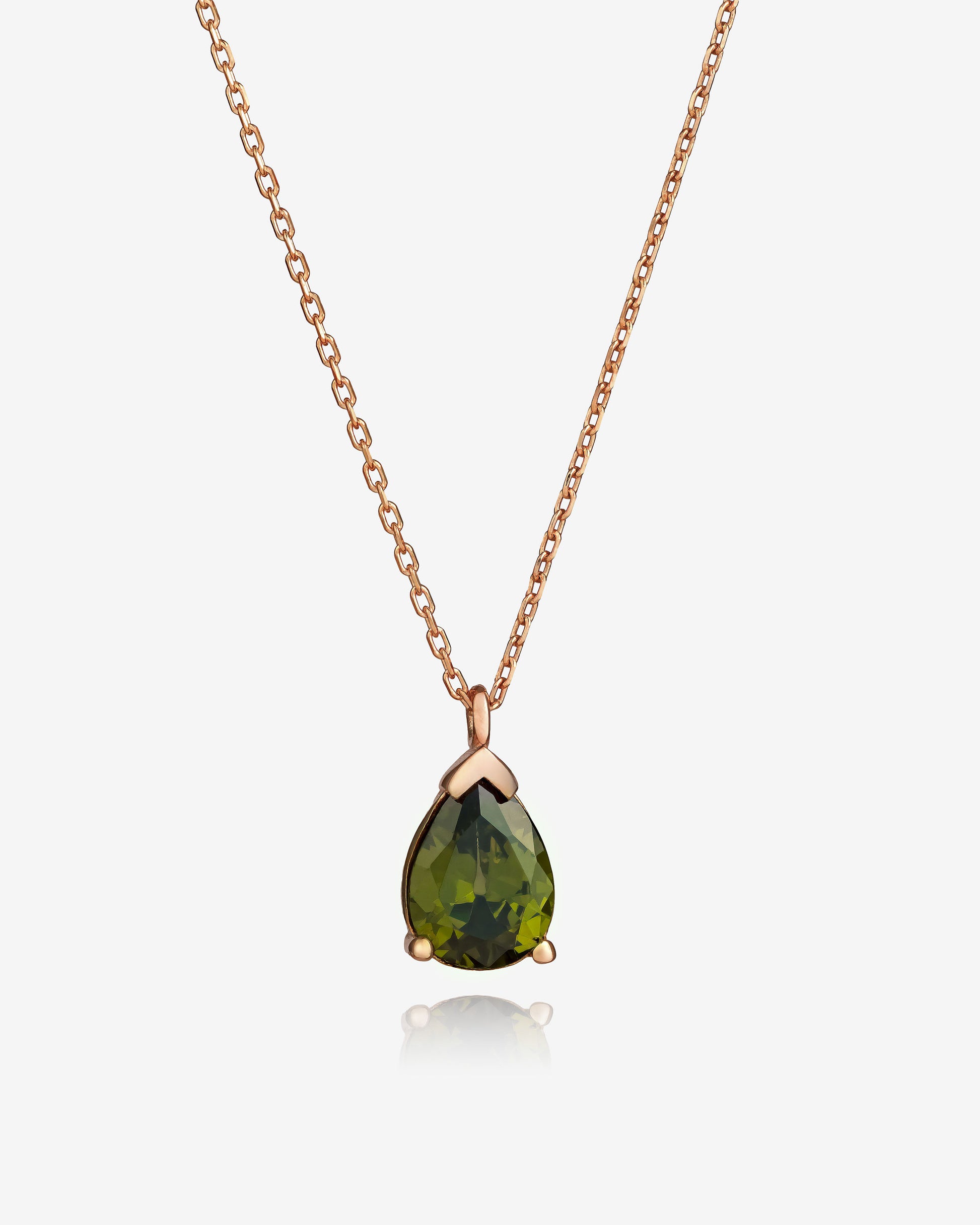 Rose gold necklace with a green teardrop pendant on a white background