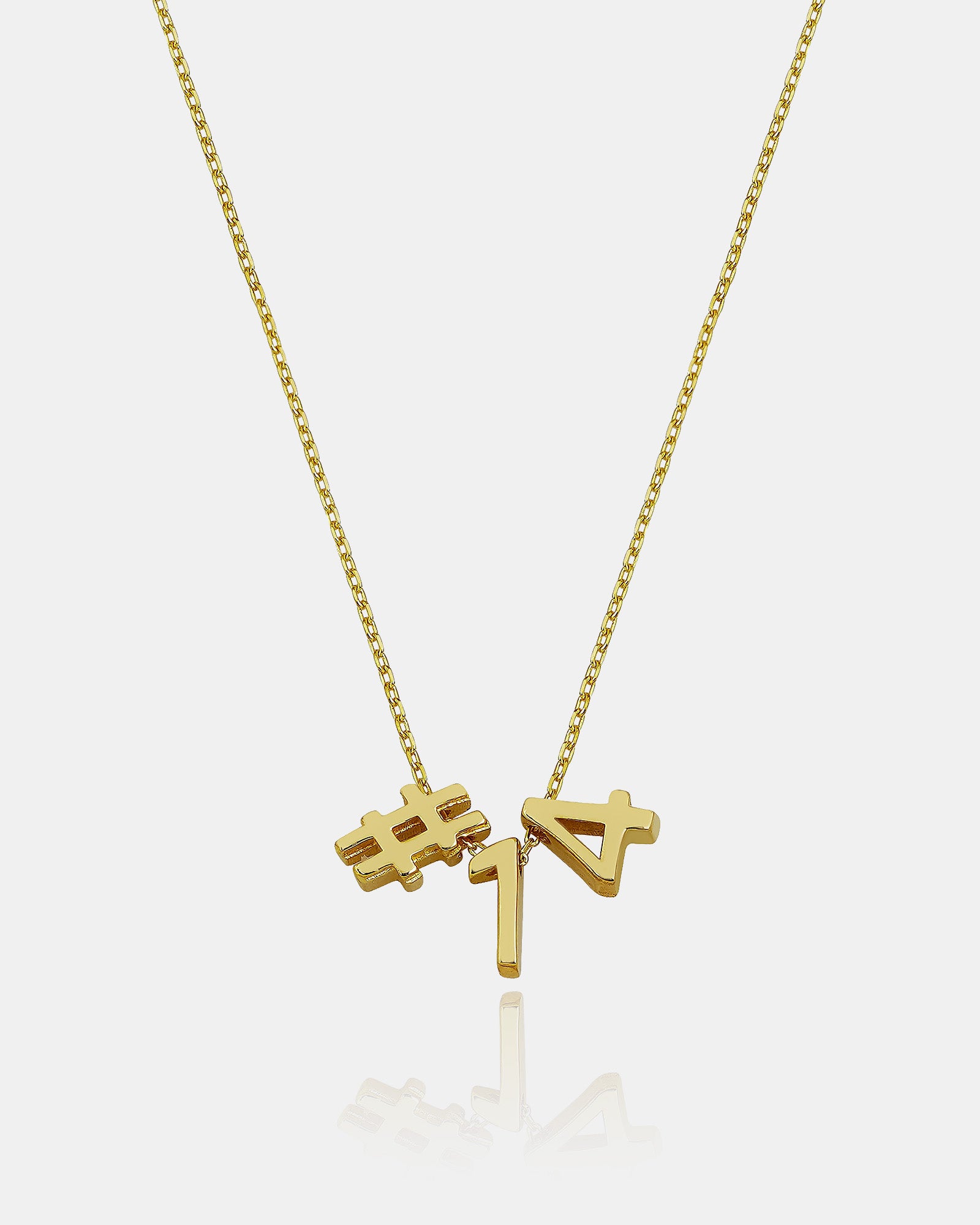Gold necklace with '#1' and '7' pendants on a white background
