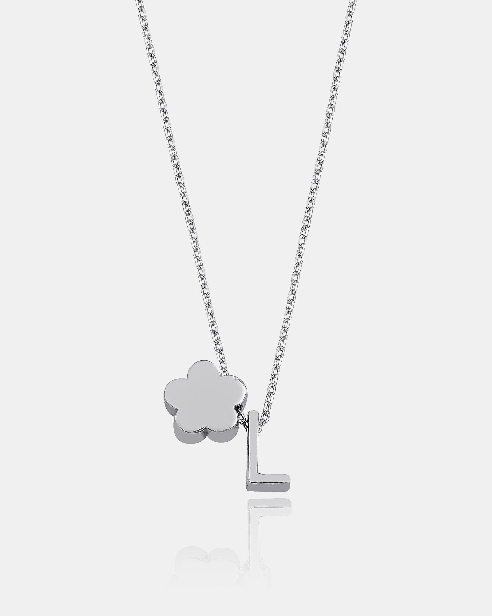 Silver necklace with a clover-shaped pendant and letter 'L' on a white background
