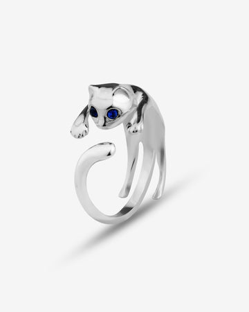 Silver cat-shaped ring with a blue gemstone on a white background
