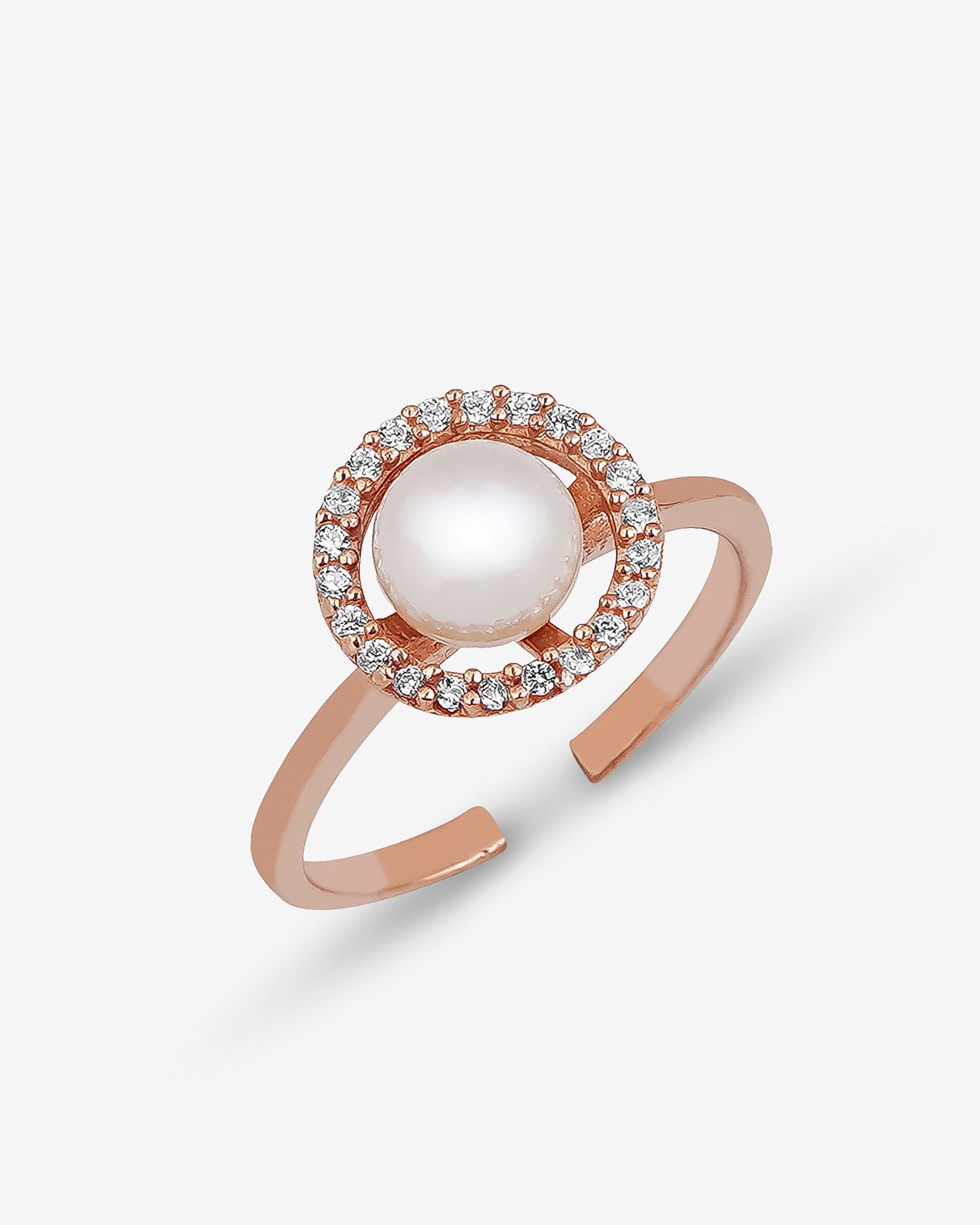 Rose gold ring with a pearl and small diamonds on a light gray background