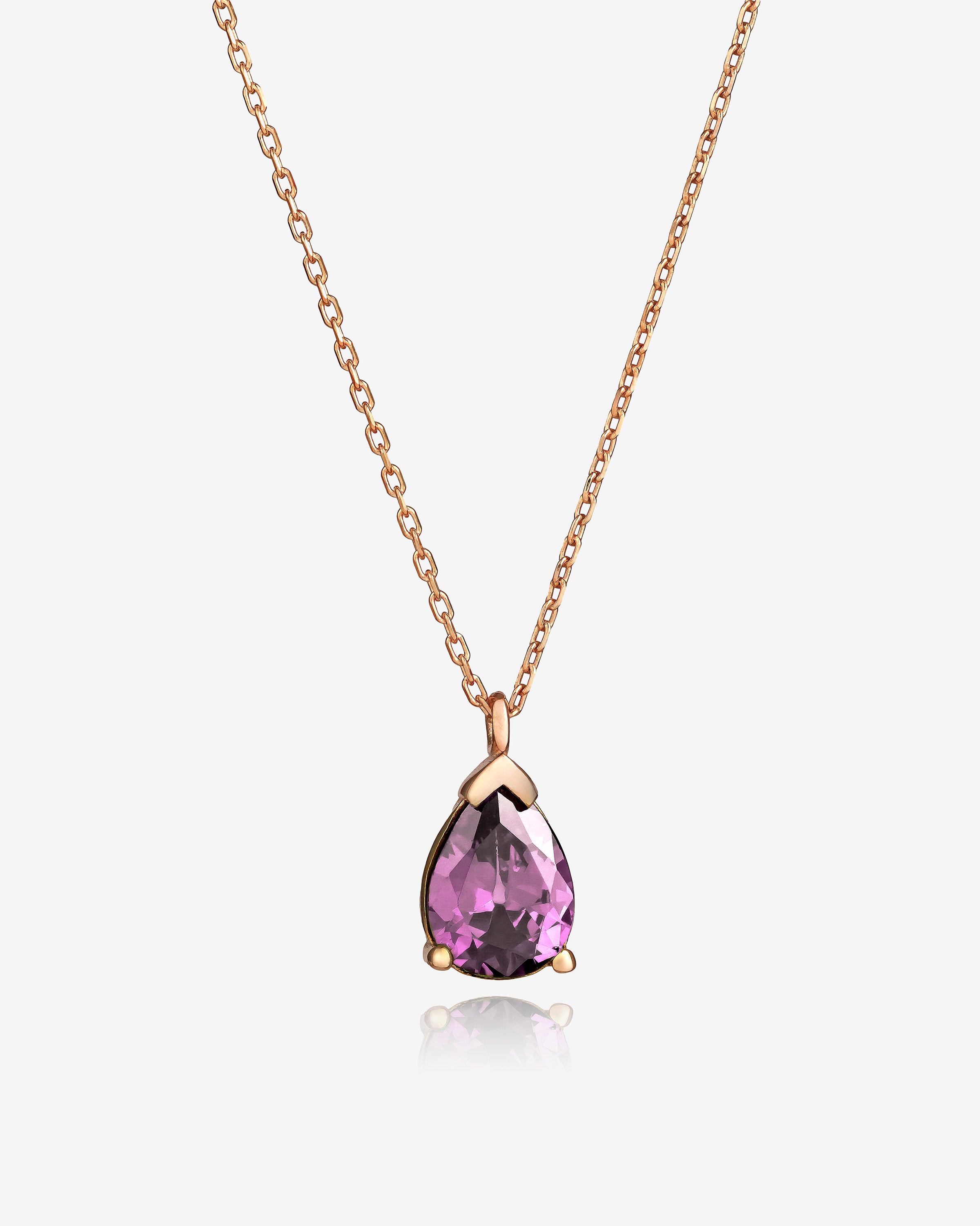 Rose gold necklace with a pink teardrop pendant on a white background