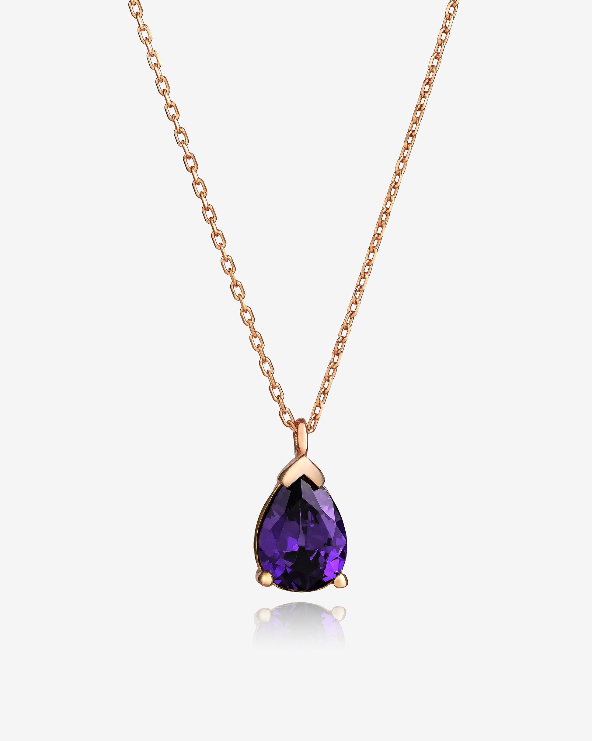 Rose gold necklace with a purple teardrop pendant on a white background