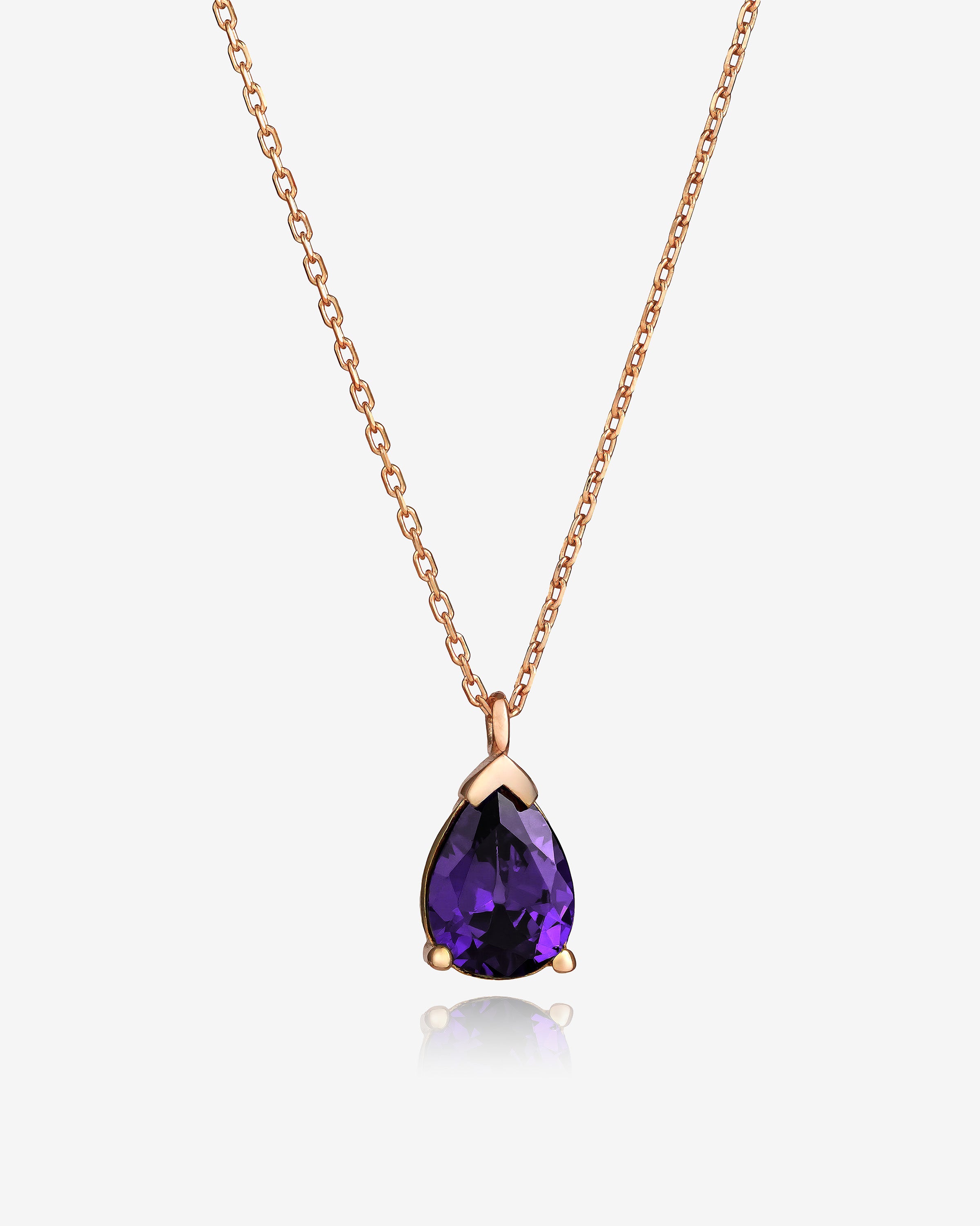Rose gold necklace with a purple teardrop pendant on a white background