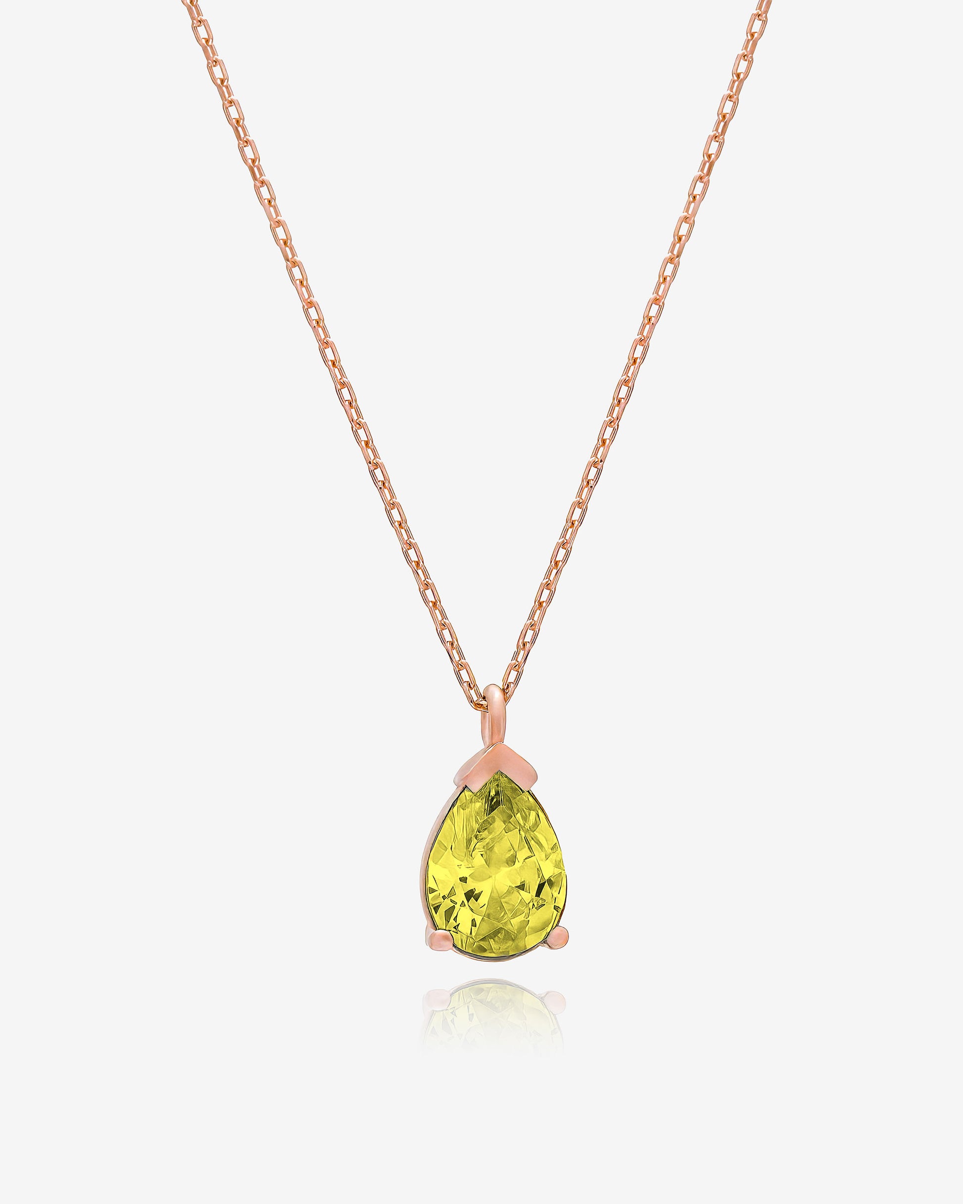 Necklace with a green teardrop pendant on a white background